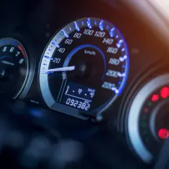 Deska rozdzielcza samochodu z podświetlanym licznikiem i obrotomierzem. Czy przebieg samochodu ma znaczenie? 92382 km.