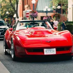 Czerwony Chevrolet Corvette na ulicy. Zastanawiasz się, ile wynosi cło z USA na samochód?